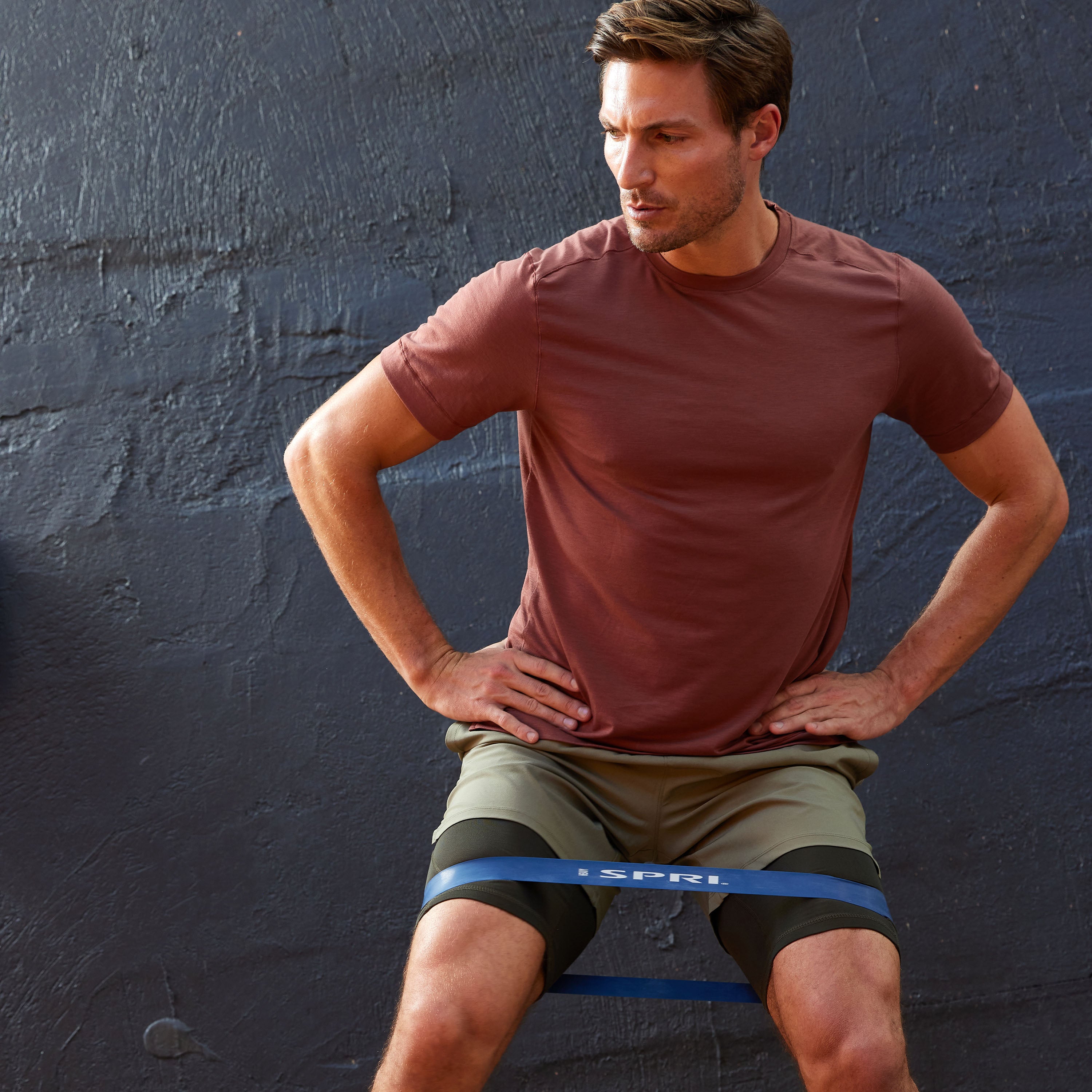 Person with Mini Loop Band on upper thighs in a standing squat position