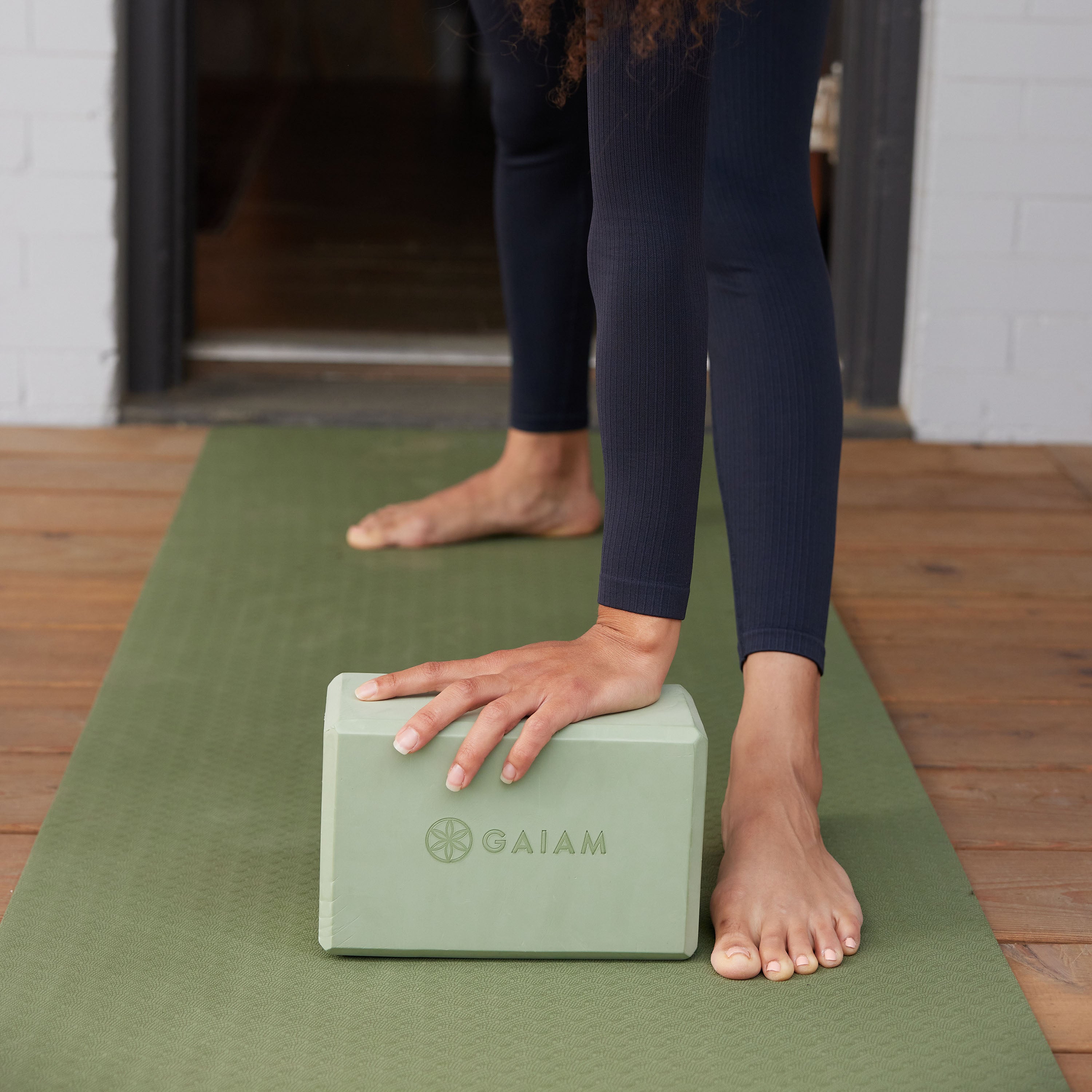 Yoga block with hand on top in stretch